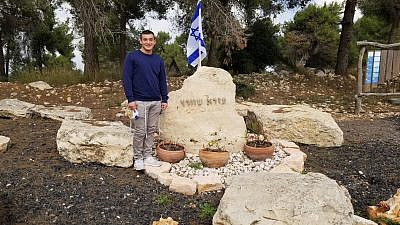 Hillel Schwartz by the grave of his brother, Ezra Schwartz, who was killed in a Palestinian terror attack in Israel on Nov. 19, 2015. Credit: Courtesy.
