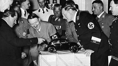 Adolf Hitler and Porsche company founder Ferdinand Porsche (left) ogle a model of the original Volkswagen Beetle. File photo.
