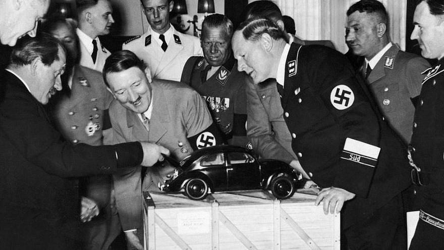 Adolf Hitler and Porsche company founder Ferdinand Porsche (left) ogle a model of the original Volkswagen Beetle. Credit: JNS File Photo.