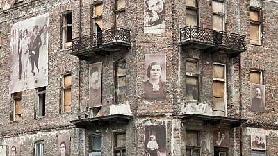 A building from the Warsaw Ghetto with pictures of Jews on the facade. Credit: Anastasia Petrova/Shutterstock.