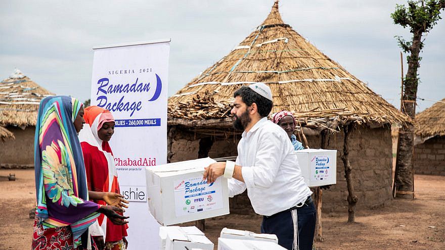 Rabbi Israel Uzan of Chabad Lubavitch of Nigeria hands out a box of food for use at the end of Ramadan. Credit: Chabad Lubavitch of Nigeria.