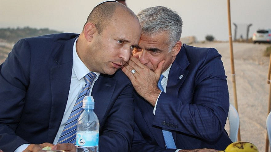 Yair Lapid and Naftali Bennett at an event inaugurating a new monument in memory of Emannuel Morano, in the Netiv Avot neighborhood in Gush Etzion, on July 23, 2017. Photo by Gershon Elinson/Flash90.