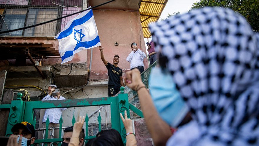 Arabs and left-wing activists protest against the eviction of Arab families from Jewish-owned homes in the eastern Jerusalem, neighborhood of Sheikh Jarrah. April 16, 2021. Photo by Yonatan Sindel/Flash90.