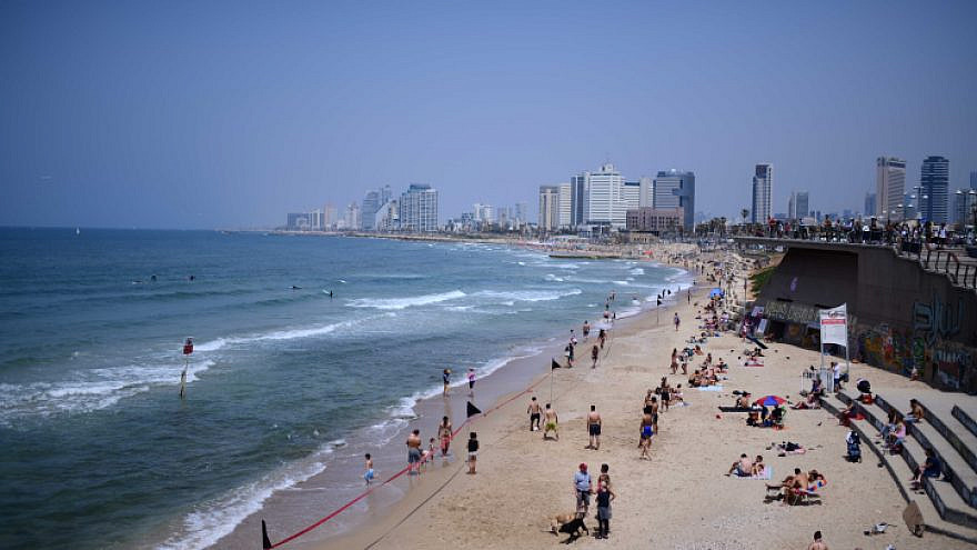 Israelis enjoy the beach outside the Old City of Jaffa, on April 24, 2021. Photo by Tomer Neuberg/Flash90.