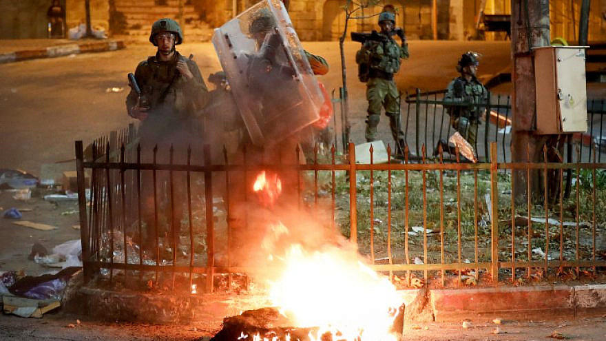 Palestinian youth in the West Bank city of Hebron clash with Israeli security forces amid unrest in Jerusalem, April 26, 2021. Photo by Wisam Hashlamoun/Flash90.