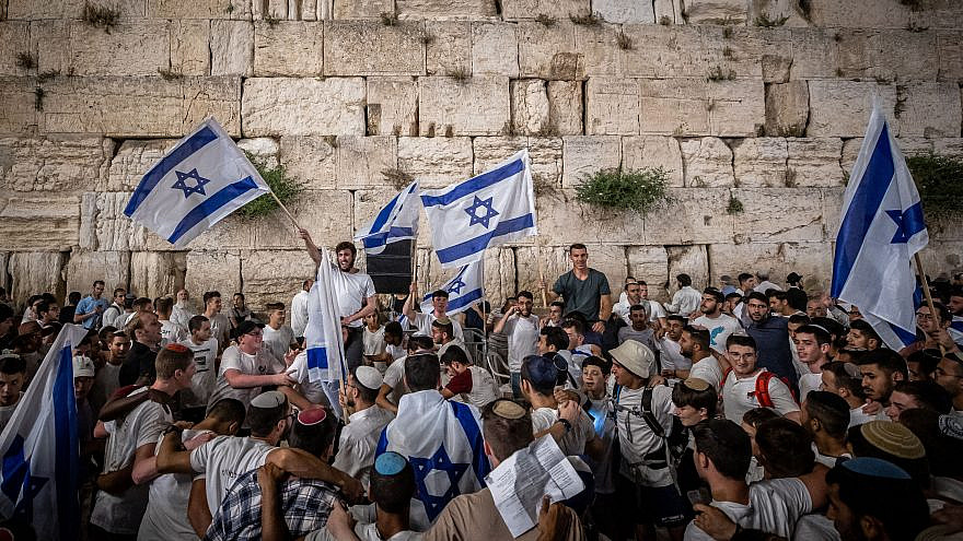 Jews dance with Israeli flags at the Western Wall on the eve of Jerusalem Day, May 9, 2021. Photo by Yonatan Sindel/Flash90.