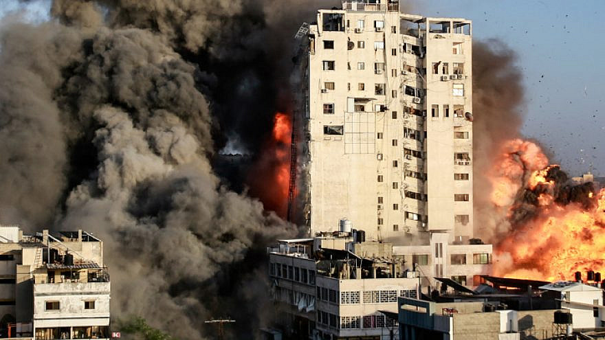 Smoke and flames rise from a tower building hit by an Israeli airstrike in Gaza City in the Gaza Strip on May 12, 2021. Photo by Atia Mohammed/Flash90.