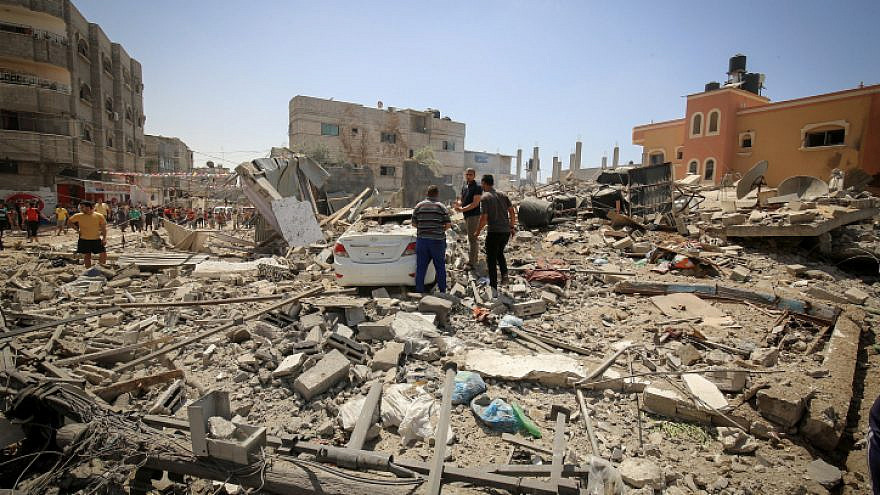 Palestinians at the site of a building hit by an Israeli airstrike in Rafah in the Gaza Strip in retaliation for more than 4,000 rockets fired by Hamas and other terror factions towards Israel, May 20, 2021. Photo by Abed Rahim Khatib/Flash90.