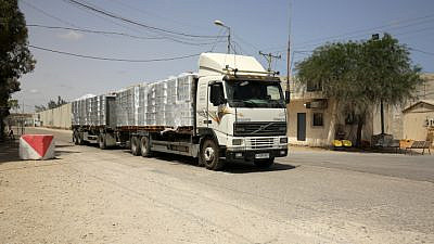 A truck loaded with humanitarian aid passes through the Kerem Shalom border crossing, the main passage point for goods entering the Gaza Strip from Israel, May 21, 2021. Photo by Abed Rahim Khatib/Flash90.