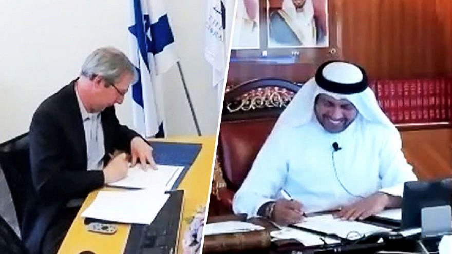 National Library of Israel director Oren Weinberg (left) and Abdulla M. Alraisi, director of the National Archive of the United Arab Emirates at Abu Dhabi, sign a memorandum of understanding laying out various areas of collaboration between the two institutions, Credit: National Library of Israel/UAE National Archive.