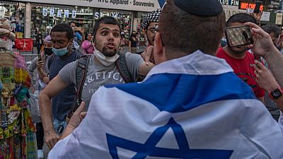 Pro-Palestinian protesters face off with police in a violent clash in Times Square during a pro-Israeli rally resulting in dozens of arrests, May 2021. Credit: Ron Adar/Shutterstock.