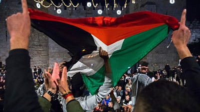Arabs gather and wave a Palestinian flag at the Damascus Gate in Jerusalem's Old City, during the Muslim month of Ramadan, April 26, 2021. Photo by Olivier Fitoussi/Flash90.