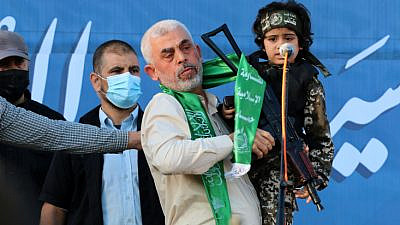 Hamas chief in Gaza Yahya Sinwar holds a Palestinian child dressed as a Hamas terrorist during a rally in Gaza City, May 24, 2021. Photo by Atia Mohammed/Flash90.