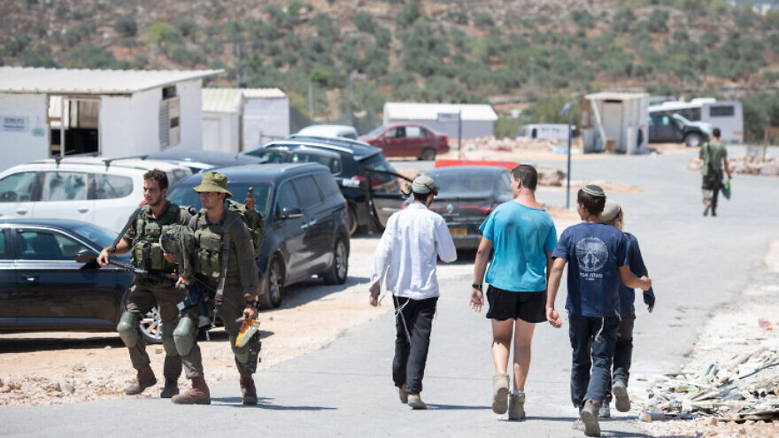 Soldiers and residents seen in the enclave of Evytar in Samaria on June 27, 2021. Photo by Sraya Diamant/Flash90