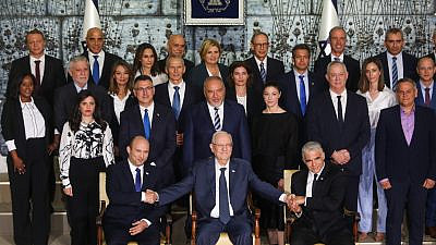 Israeli Prime Minister Naftali Bennett (front row, left), Israeli President Reuven Rivlin, Israeli Foreign Minister Yair Lapid (front row, right) and Israeli ministers pose for a group photo of the newly sworn-in Israeli government, at the President's Residence in Jerusalem on June 14, 2021. Photo by Yonatan Sindel/Flash90.