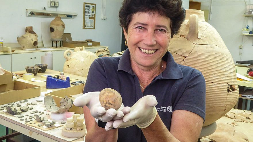 Archeologist Alla Nagorsky holding the ancient egg, June 2021. Credit: Israel Antiquities Authority.