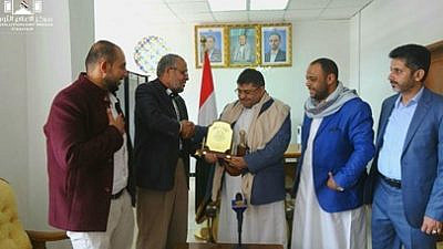 Hamas representative in Yemen Mo'az Abu Shamala presents Muhammad Ali al-Houthi. a member of the Houthi Supreme Political Council. with a "shield of honor" as a token of appreciation for the Houthis' support of the Palestinian cause, June 6, 2021. Credit: Palinfo.com via MEMRI.
