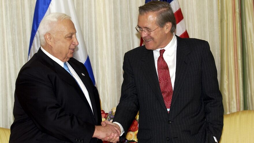 Former U.S. Defense Secretary Donald Rumsfeld with former Israeli Prime Minister Ariel Sharon in October 2002. Credit: Avi Ohayon/GPO.