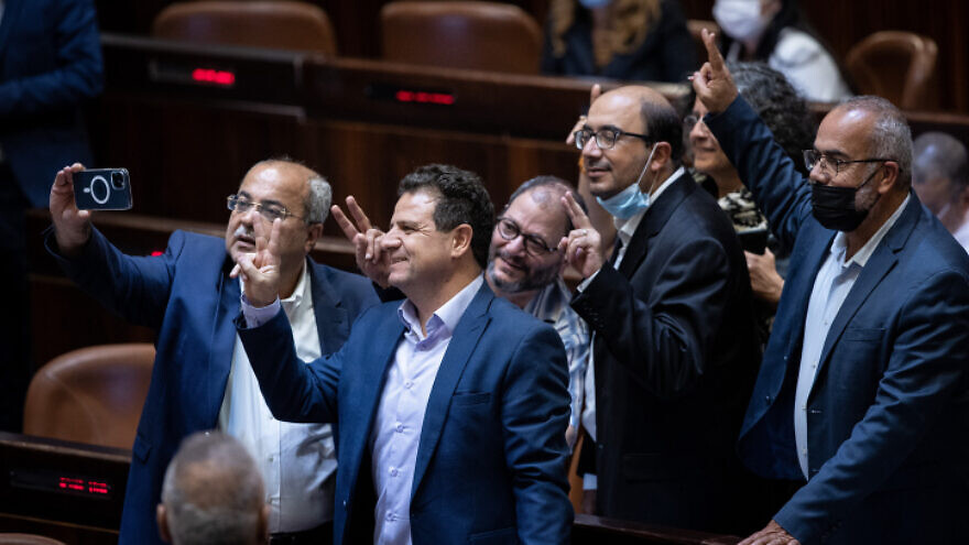 Members of the Arab Joint List take a selfie following a discussion on the "family reunification law", during a plenum session in the assembly hall of the Israeli parliament, in Jerusalem, on July 6, 2021. Photo by Yonatan Sindel/Flash90.