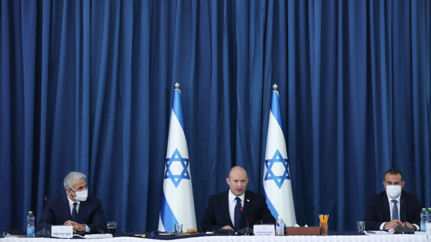 Israeli Prime Minister Naftali Bennett (center) and Foreign Minister Yair Lapid (left) during a Cabinet meeting at the Ministry of Foreign Affairs in Jerusalem on Aug. 8, 2021. Photo by Ohad Zwigenberg/POOL.