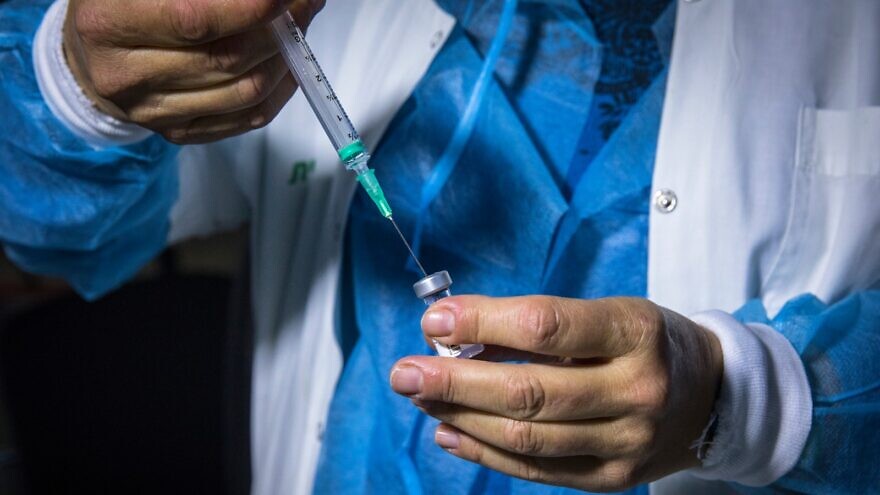 A medical professional preparing a COVID-19 vaccine in Jerusalem. Photo by Olivier Fitoussi/Flash90.