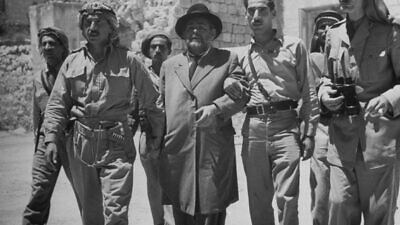 Jerusalem Mayor Mordechai Weingarten is accompanied by Arab fighters at the end of May 1948 to sign surrender documents to the city, specifically to the Jewish Quarter, where generations of Jewish families had lived and were forced to evacuate. It would remain restricted to Jews until June 1967, as a result of the Six-Day War, May 1948. Courtesy: John Phillips, “Life” magazine, as reprinted in his book, “A Will to Survive.”