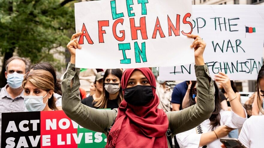 Hundreds of people in New York demand that the United States accept all Afghan people seeking asylum as U.S. troops withdraw from the country after 20 years, August 2021. Credit: Luigi Morris/Shutterstock.