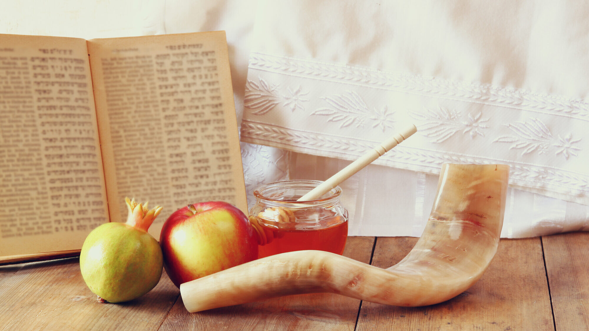 Apples and honey, a pomegranate and a shofar, all traditionally involved with the Jewish holiday of Rosh Hashanah. Credit: Tomertu/Shutterstock.