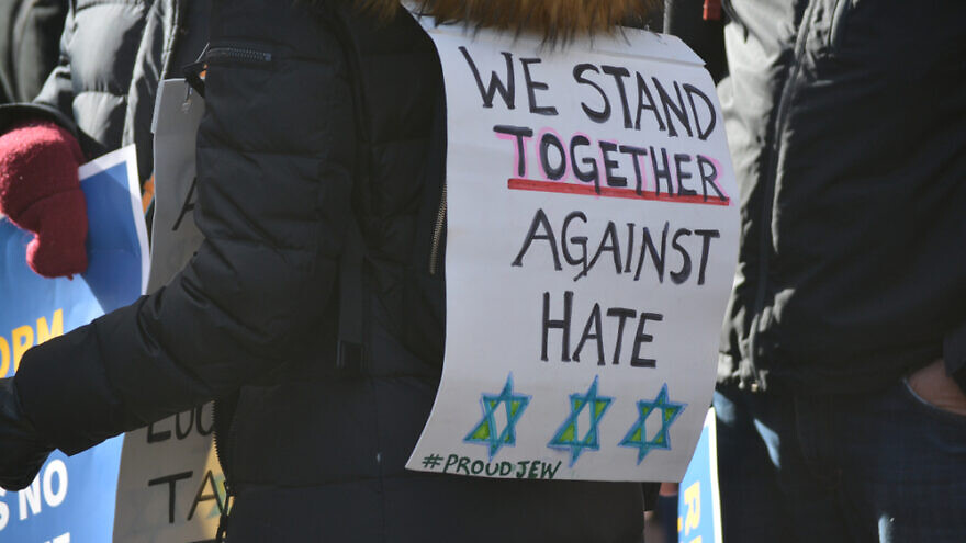 Signs worn by those participating in a march from Manhattan to Brooklyn protesting a rise in anti-Semitism, Jan. 5, 2020. Credit: Christopher Penler/Shutterstock.