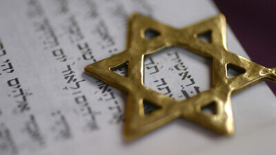 A Star of David pointer over the first word of the book of Genesis. Credit: Odelia Cohen/Shutterstock.