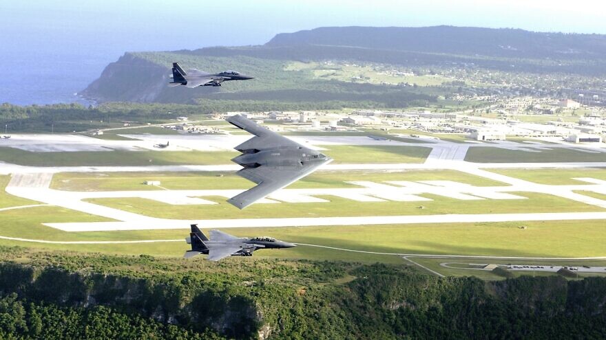 U.S. F-15E Strike Eagles and a B-2 Spirit bomber fly in formation over Andersen Air Force Base in Guam in July 2005. Credit: U.S. Air Force Photo by Tech. Sgt. Cecilio Ricardo via Wikimedia Commons.