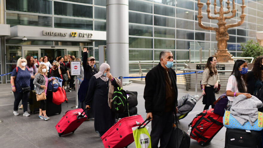 Travelers arrive at Ben-Gurion International Airport as Israel reopens its borders to individual foreign tourists. Nov. 1, 2021. Photo by Tomer Neuberg/Flash90.