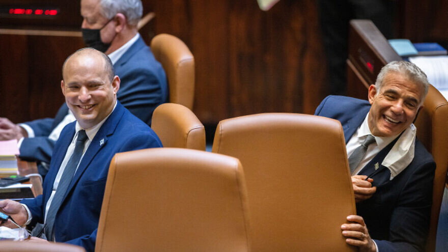 Israeli Prime Minister Naftali Bennett (left) and Foreign Minister Yair Lapid attend a plenum session and a vote on the 2021 state budget at the Knesset, on Nov. 3, 2021. Photo by Olivier Fitoussi/Flash90.