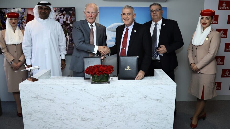 Israel Aerospace Industries announced an agreement to convert four B777-300ER passenger aircraft into cargo planes for the Emirates airline, with representatives from both sectors at the signing on Nov. 15, 2021. Credit: Courtesy.
