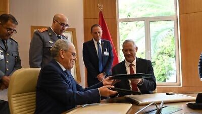 Israeli Defense Minister Benny Gantz (right) signs a memorandum of understanding with his counterpart, Moroccan Minister Delegate to the Head of Government in Charge of National Defense Abdellatif Loudiyi, Nov. 24, 2021. Credit: Ariel Hermoni/Israeli Defense Ministry.