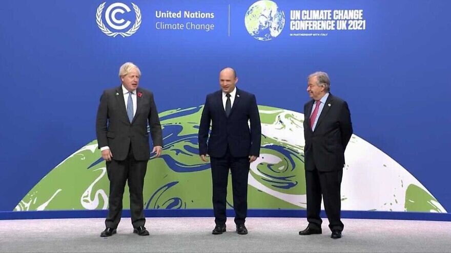 British Prime Minister Boris Johnson (left), Israeli Prime Minister Naftali Bennett (center) and U.N. Secretary- General António Guterres share a stage at the 26th U.N. Climate Change Convention (COP26) in Glasgow, Scotland, Nov. 1, 2021. Credit: Courtesy.