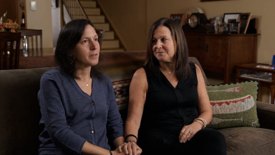 Michele Rosenberg (left) is comforted by her sister, Diane, as she speaks of the deaths of their brothers, Cecil and David Rosenberg, 59 and 54, who they said knew prayers by heart since they attended synagogue every week. Credit: Courtesy of “A Tree of Life” documentary.