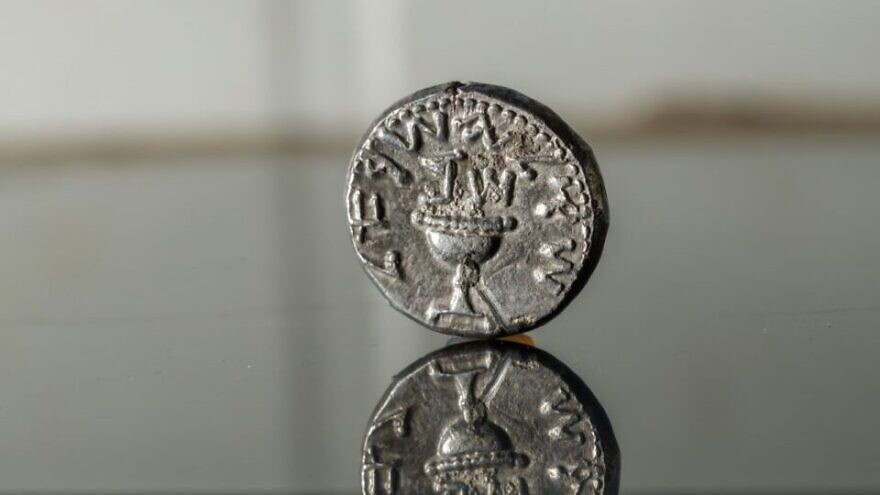 A 2,000-year-old silver coin found in debris from an excavation in the City of David. The inscription on the coin reads "Shekel Yisrael," and above the chalice are the Hebrew letters "Shin" and "Bet," an acronym for "Shana Bet," or Year Two of the Jewish revolt against Rome. Credit: Eliyahu Yanai/ City of David.