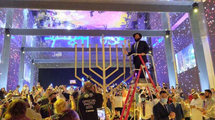 Rabbi Levi Druchman lights the Hanukkah menorah at the Israeli pavilion at EXPO 2020 in Dubai, Nov. 28, 2021. Credit: UAE Jewish Community.