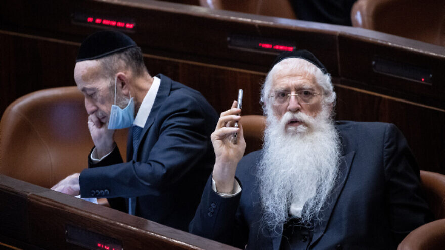 Knesset members Meir Porush (right) and Uri Maklev attend a plenary session at the Knesset, July 14, 2021. Photo by Yonatan Sindel/Flash90.