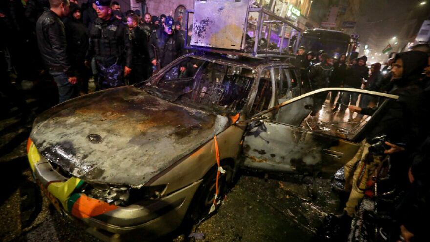 Palestinians gather around the car of Israelis who got lost in Ramallah and were rescued from an angry mob that set the vehicle on fire on Dec. 1, 2021. Photo by Flash90.