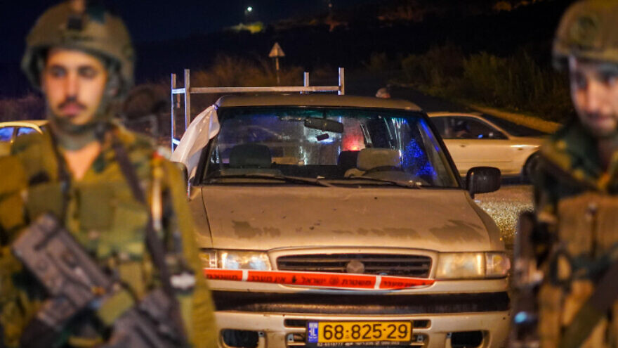 Israeli security forces inspect the scene of a shooting attack near Homesh, in Judea and Samaria, on Dec. 16, 2021. Photo by Hillel Maeir/Flash90.