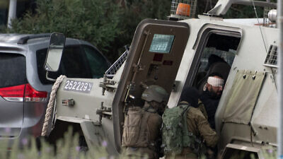 Israeli special forces arrest a Palestinian man outside Shavei Shomron, in Judea and Samaria, on Dec. 17, 2021, following a fatal terror attack near Homesh the night before. Photo by Sraya Diamant/Flash90.