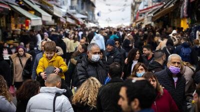 People shop at the Machane Yehuda open-air market in Jerusalem on Dec. 24, 2021. Photo by Olivier Fitoussi/Flash90.