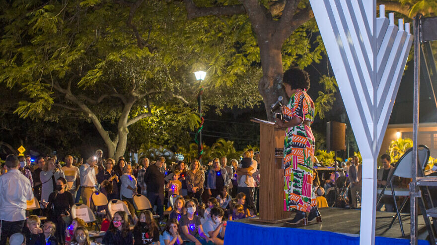More than 300 people came to a public menorah-lighting on the third night of Hanukkah, sponsored by Chabad of Miami Shores in Florida with the appearance of former Mayor Crystal Wagar (at podium), Nov. 30, 2021. Credit: Courtesy of Chabad of Miami Shores.