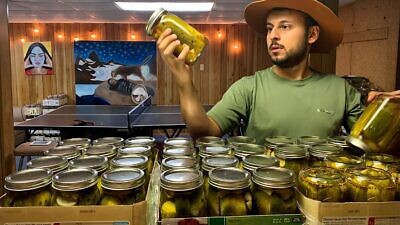 Edward Ilyasov of Queens, N.Y., inspects his batches of pickles. Credit: Courtesy.