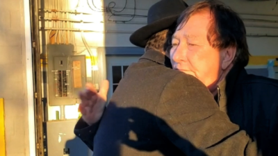 Rabbi Shlomo Litvin, co-director of Chabad of the Bluegrass, embraces a resident in one of Kentucky's hard-hit areas after a series of tornadoes decimated homes and other buildings in parts of the state, December 2021. Source: Rabbi Sholom Litvin/Twitter.