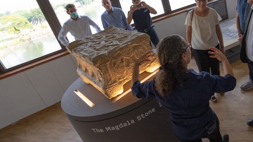 Einat Ambar Armon, curator of the Sanhedrin Trail exhibition on behalf of the Israel Antiquities Authority, presents the Magdala Stone. Photo by Yair Amitzur/Israel Antiquities Authority.