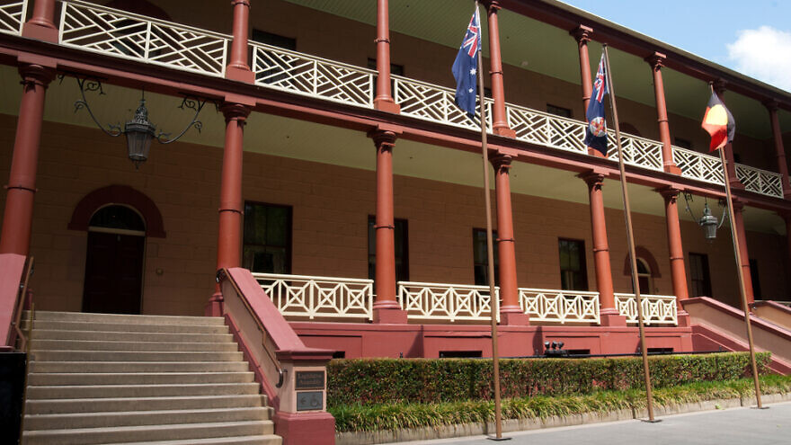 The facade of New South Wales parliament house on Macquarie Street with Australian, New South Wales and aboriginal flags raised. Credit: Demamiel62/Shutterstock.