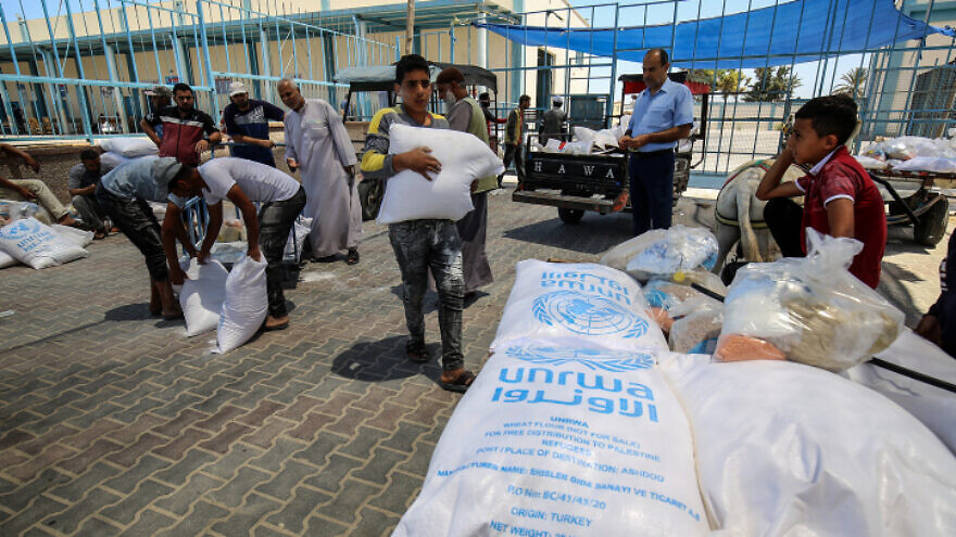 Palestinians receive food aid at an UNRWA distribution center in the southern Gaza Strip town of Rafah on May 26, 2021. Photo by Abed Rahim Khatib/Flash90.